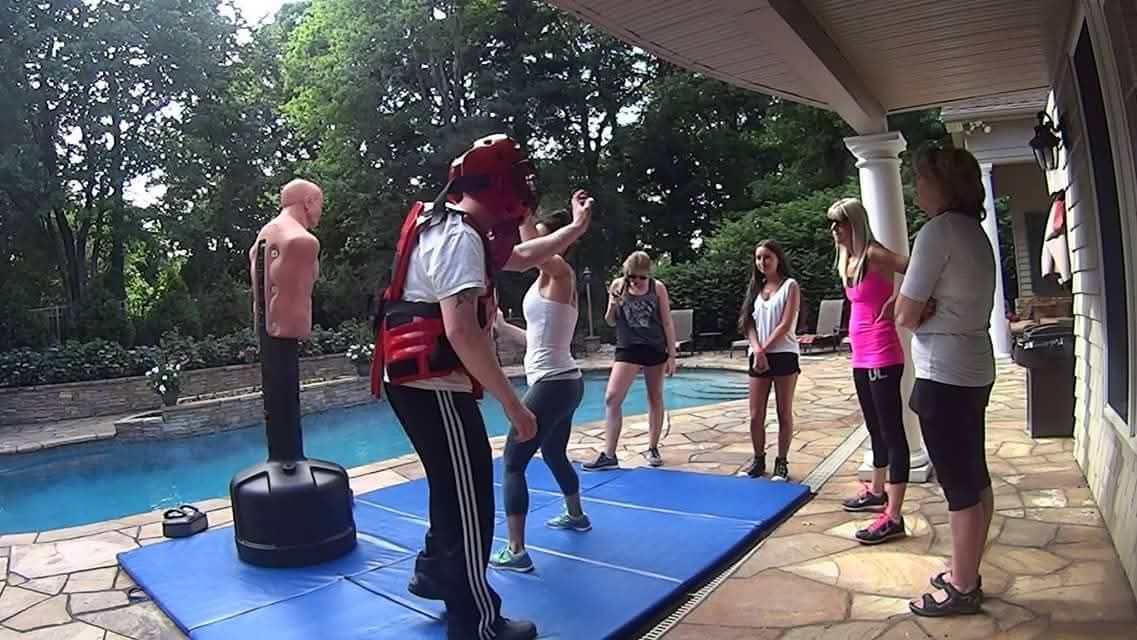 M.A.C.S. outdoor self-defense class practicing beside a pool