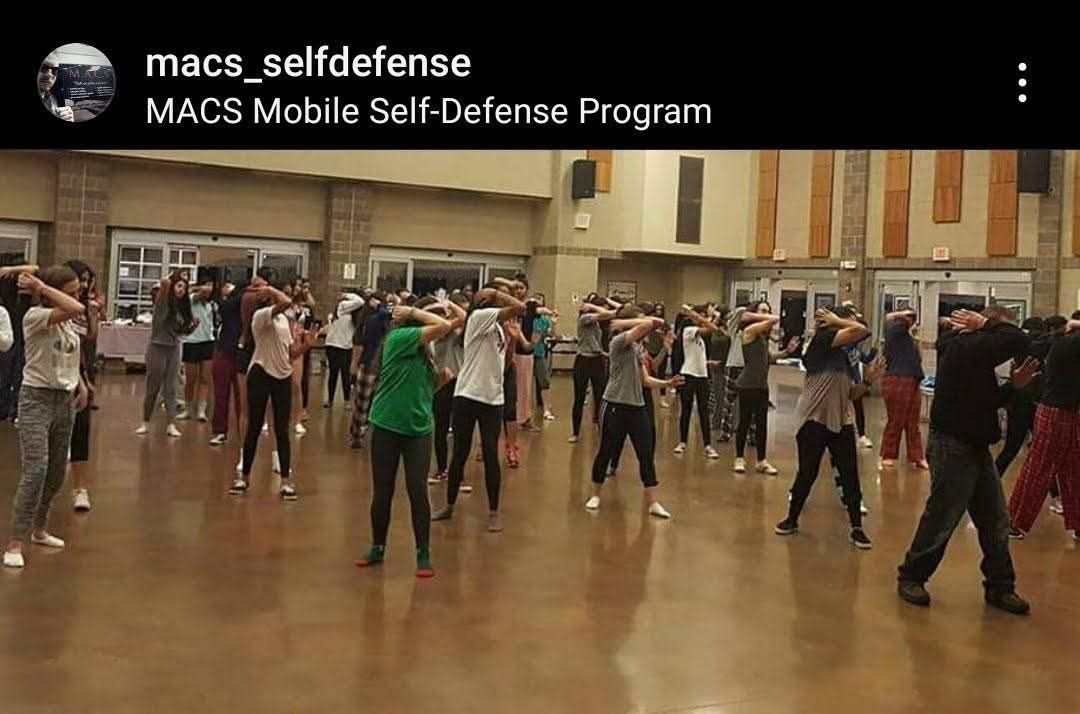 M.A.C.S. group self-defense class practicing coordinated movement